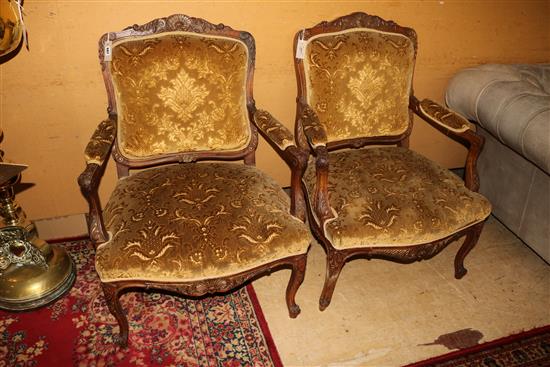 A pair of Louis XV style parcel gilt walnut fauteuils, H.3ft 1in.